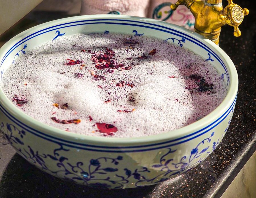 Foot spa bowl with rose petals